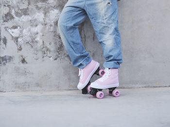 Low section of man skateboarding on wall