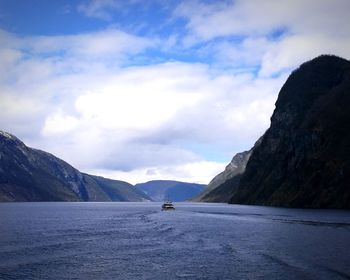 Scenic view of sea and mountains against sky