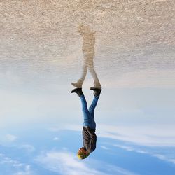 Full length of woman jumping in water