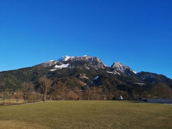 Scenic view of snowcapped mountains against clear blue sky