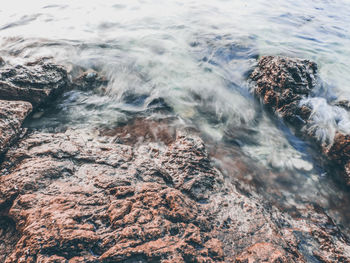 High angle view of rocks in sea