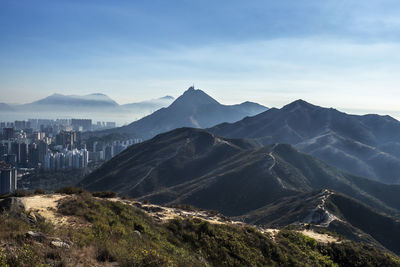 Scenic view of mountains against cloudy sky