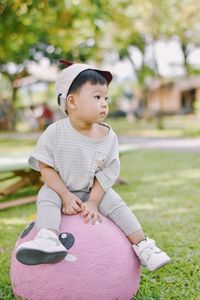 Portrait of cute girl sitting on field