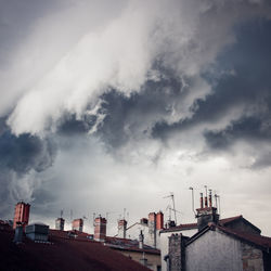 Buildings against cloudy sky