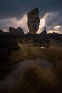 Rock formations on landscape against sky during sunset