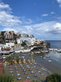 High angle view of buildings by sea against sky