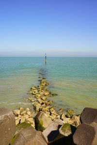 Scenic view of sea against clear blue sky