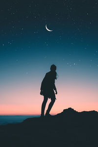 Silhouette man standing against sky during sunset
