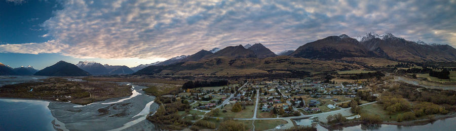 Panoramic view of buildings and mountains against sky