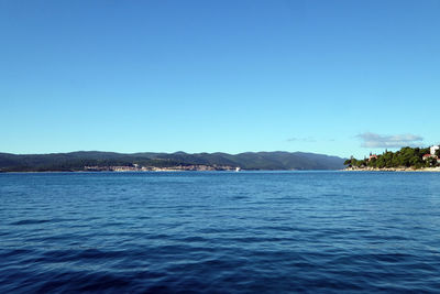 Scenic view of sea against clear blue sky