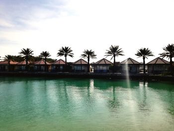 Swimming pool by building against sky