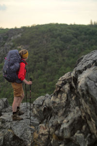 Full length of man standing on rocks against mountain
