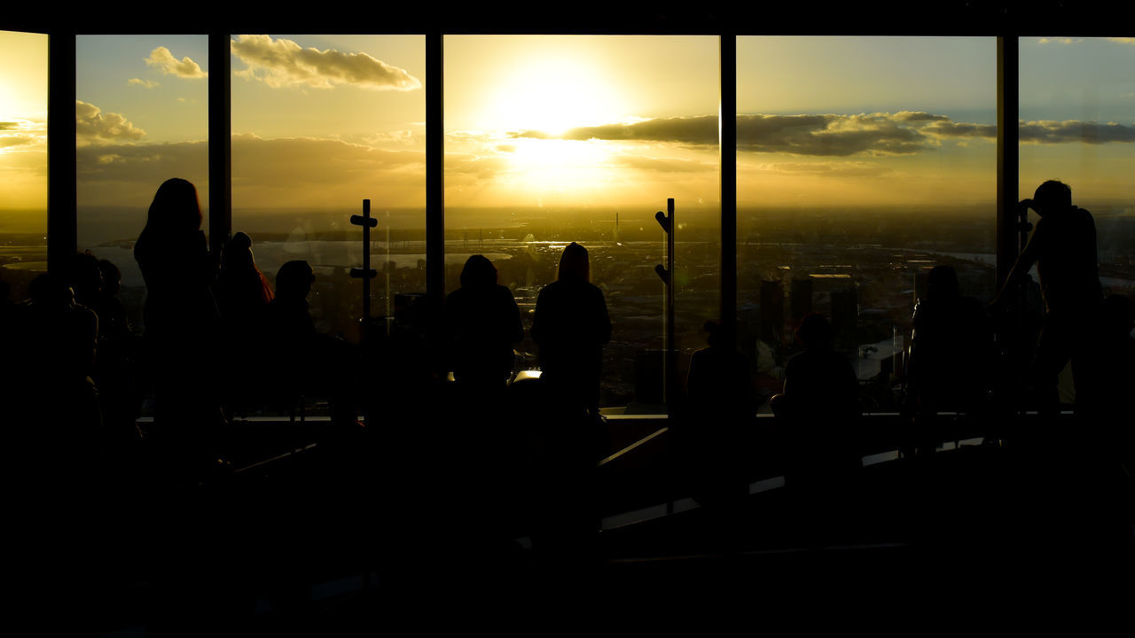 sunset, sky, silhouette, built structure, city, architecture, cloud - sky, real people, indoors, cityscape, men, nature, day, people