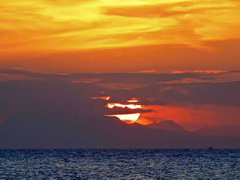 Scenic view of sea against orange sky