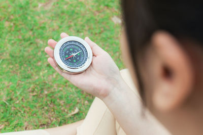 Close-up of woman holding navigational compass