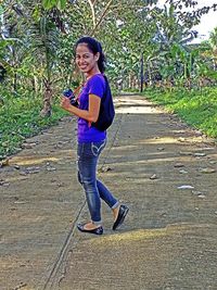 Full length of a smiling young woman