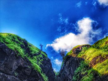 Low angle view of mountain against blue sky