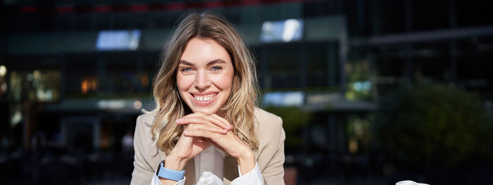 Portrait of young woman with eyes closed standing outdoors