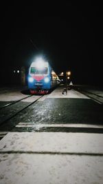 Illuminated car on road against sky at night