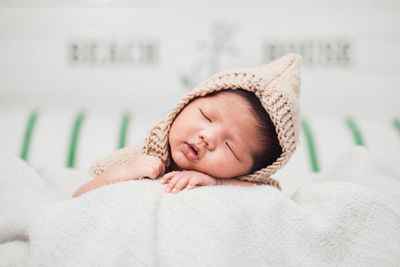 Portrait of cute baby sleeping on bed