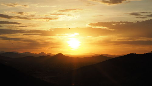 Scenic view of silhouette mountains against sky during sunset