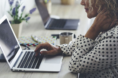 Man using laptop at table