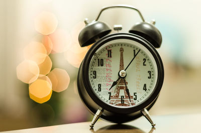 Close-up of clock on table at home