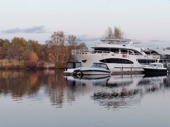 Boats moored in lake against sky