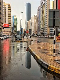 Reflection of buildings on wet road in rainy season