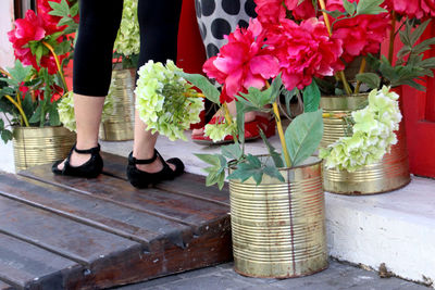 Low section of person standing by flowers