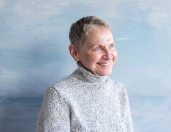 Portrait of smiling man standing against sea