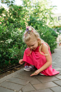 Young woman using mobile phone while sitting on bench