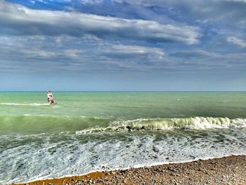 Scenic view of sea against cloudy sky