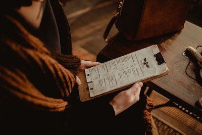 High angle view of man reading book