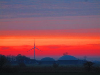 Scenic view of field against romantic sky at sunset