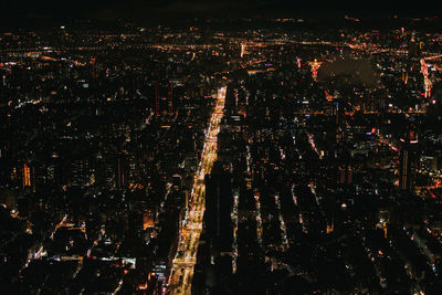 High angle view of illuminated city buildings at night