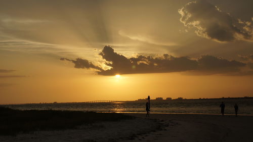 Scenic view of beach against sky during sunset