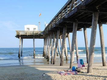 View of pier on beach against sky