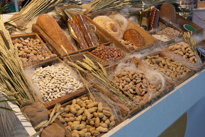  display with natural products, breads, peanuts, cheeses, almonds, beans, chickpeas, lentils, etc.