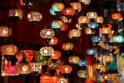 Close-up of illuminated lanterns hanging for sale