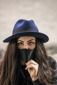 Woman wants to take off her mask so she can breathe properly. 