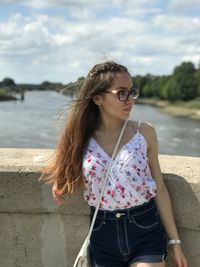 Young woman wearing sunglasses standing outdoors