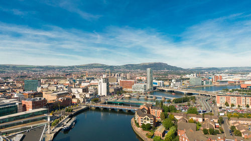 High angle view of river amidst buildings in city against sky