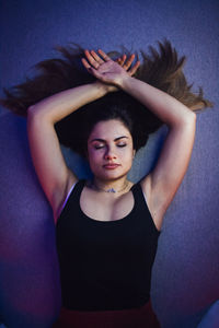 Directly above shot of young woman lying on bed