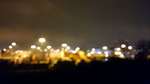 Defocused image of illuminated street lights at night