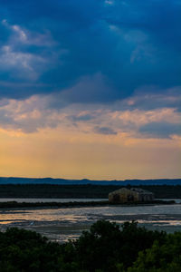 Scenic view of beach against sky during sunset