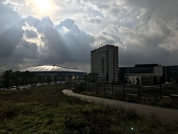 Buildings on field against sky