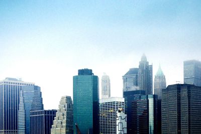 Skyscrapers in city against clear sky