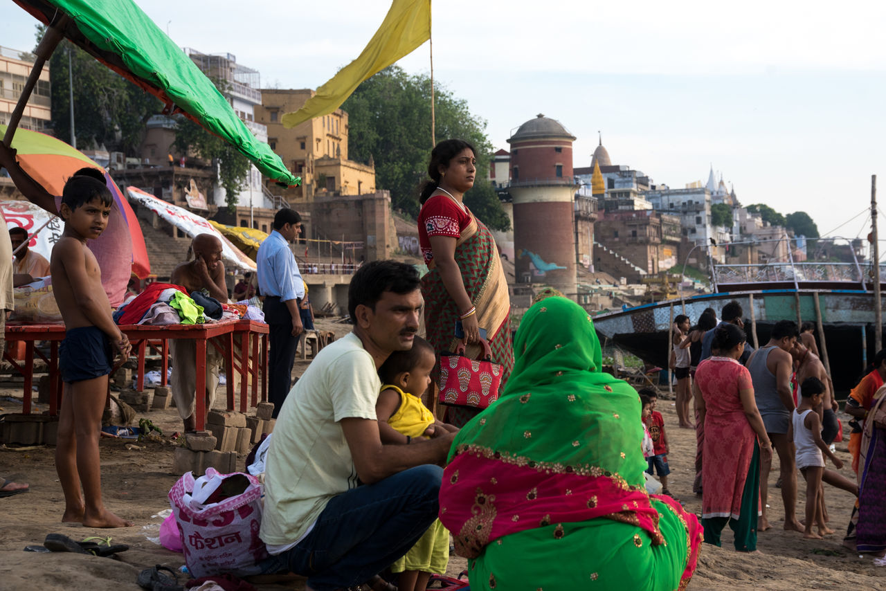 real people, group of people, architecture, crowd, built structure, sitting, women, building exterior, lifestyles, large group of people, adult, men, day, sky, market, city, leisure activity, casual clothing, market stall, outdoors, street market