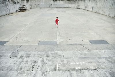 Rear view of woman walking on road